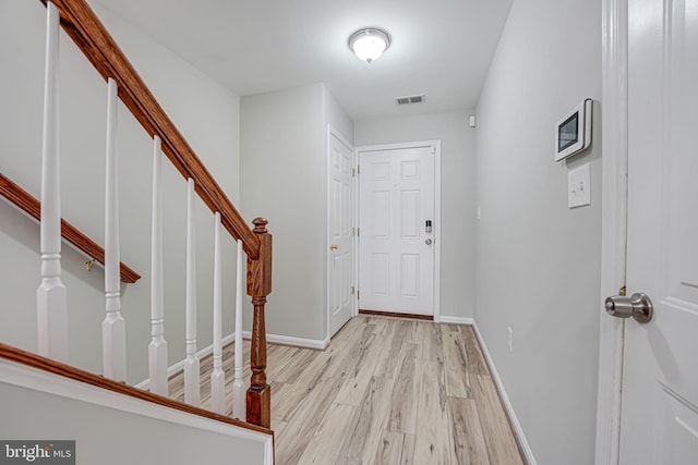 foyer entrance with light hardwood / wood-style floors