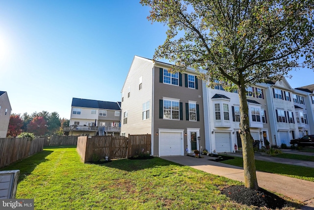 view of front of property featuring a front lawn and a garage