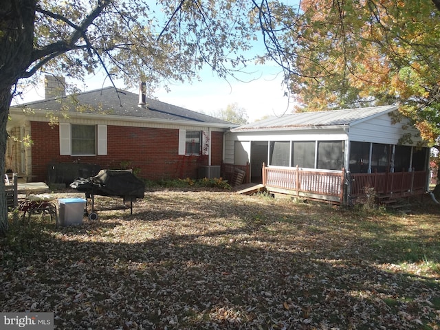 back of house featuring a sunroom