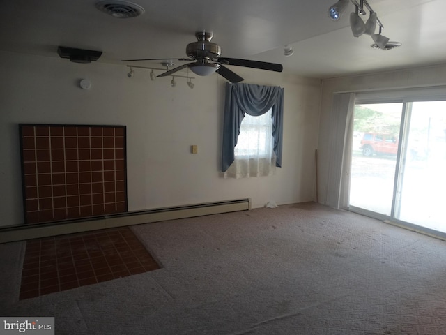 spare room featuring ceiling fan, carpet floors, and baseboard heating