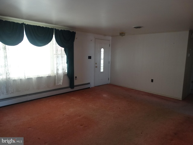 carpeted foyer entrance with a baseboard heating unit