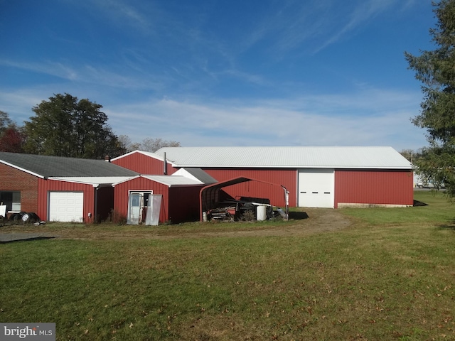 view of outbuilding with a garage and a lawn