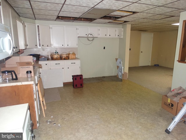 kitchen featuring white cabinetry and a paneled ceiling