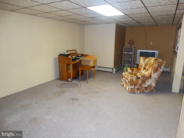 basement featuring light carpet, a drop ceiling, and baseboard heating