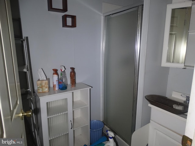 bathroom with vanity, walk in shower, and toilet