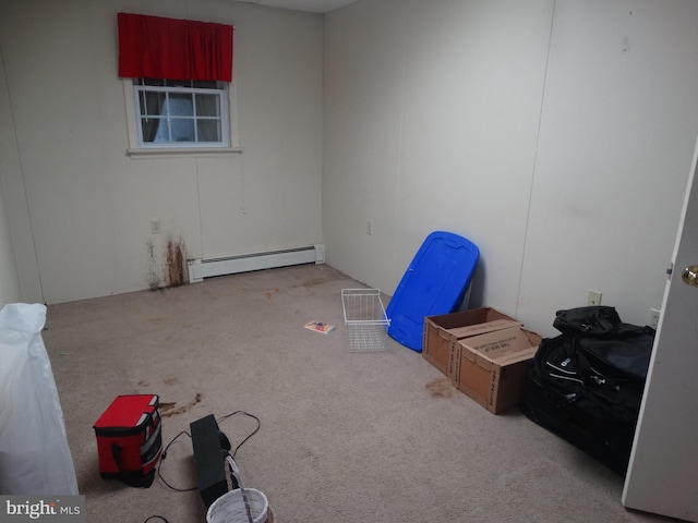 miscellaneous room with baseboard heating and light colored carpet