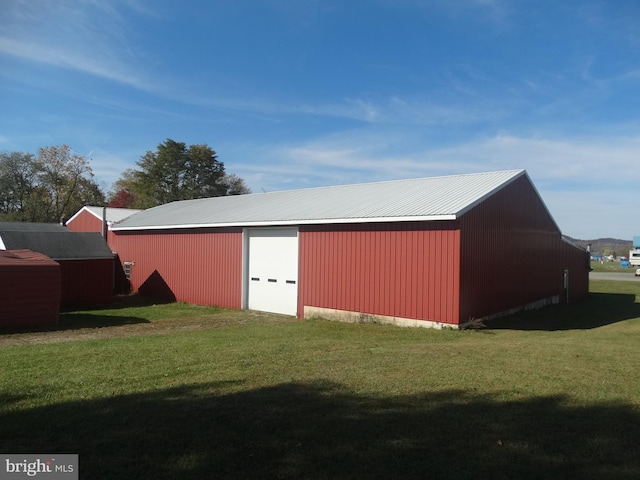 view of outdoor structure with a lawn