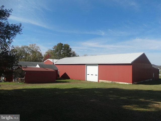 view of outbuilding with a yard