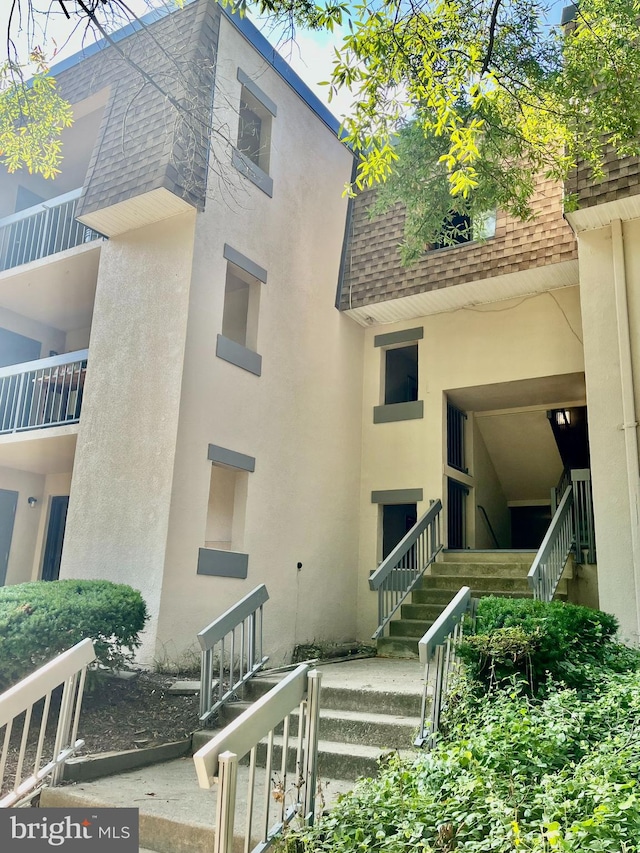 rear view of property featuring a balcony