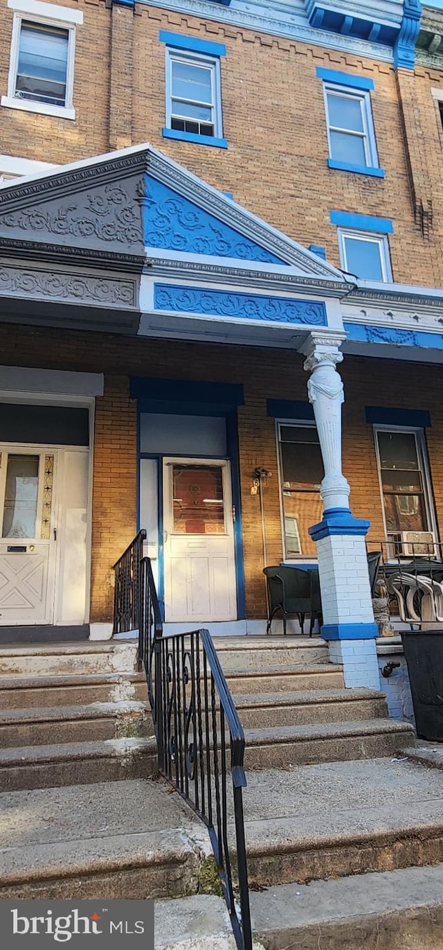 view of exterior entry with a porch