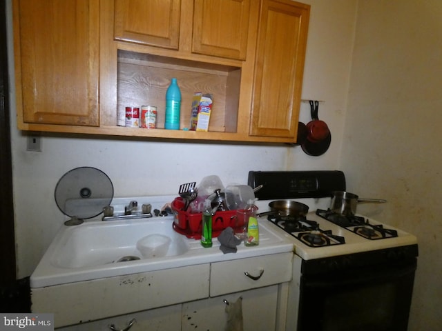 kitchen with sink and white gas range oven