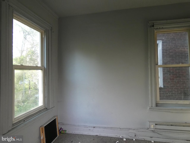 unfurnished room featuring plenty of natural light