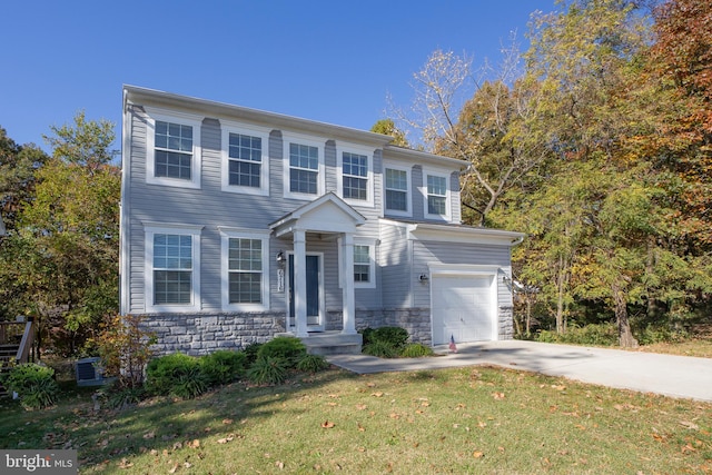 view of front of house with a front yard and a garage