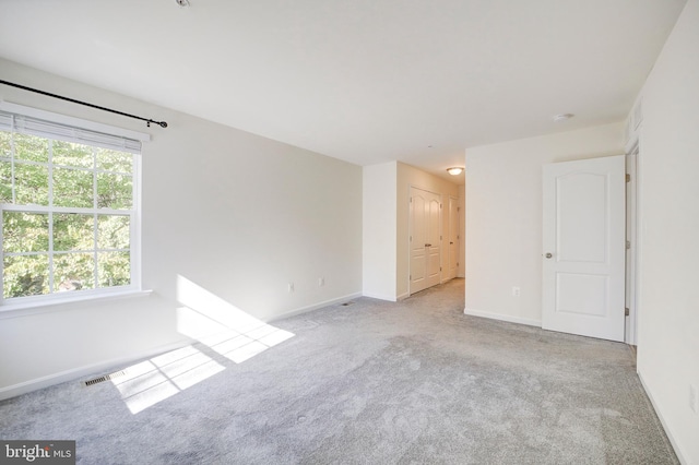 unfurnished room with light carpet