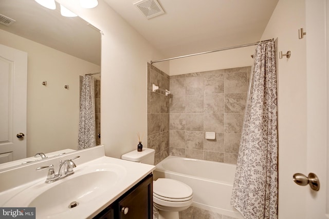 full bathroom with vanity, shower / tub combo with curtain, and toilet