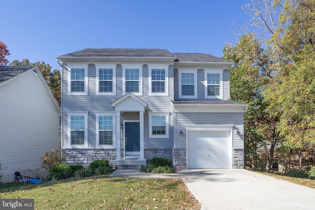 view of front of home with a front lawn and a garage