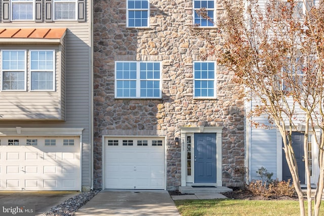 multi unit property featuring a garage