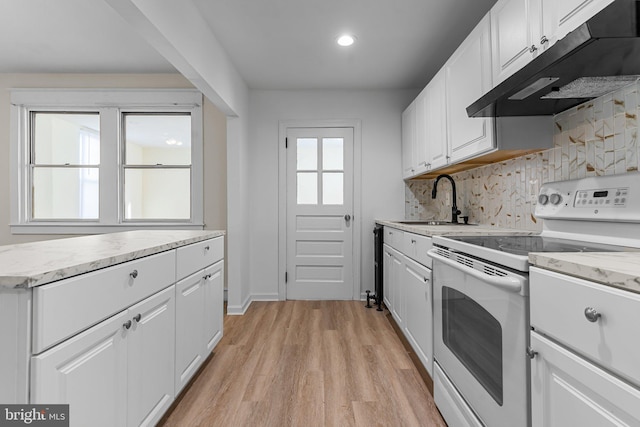 kitchen with white cabinetry, white electric range oven, light hardwood / wood-style flooring, and decorative backsplash