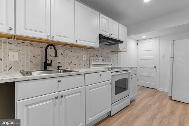 kitchen with light hardwood / wood-style floors, backsplash, sink, white cabinetry, and white appliances