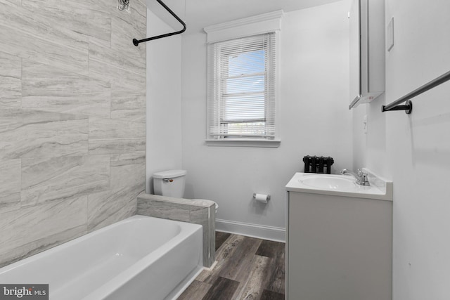 full bathroom with vanity, tiled shower / bath combo, hardwood / wood-style flooring, and toilet