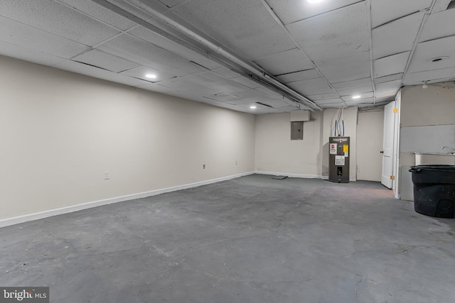 basement with a paneled ceiling, electric panel, and water heater