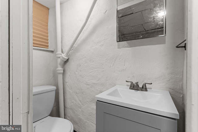 bathroom featuring toilet and vanity