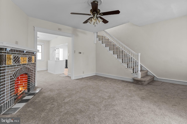 unfurnished living room with a fireplace, carpet floors, and ceiling fan