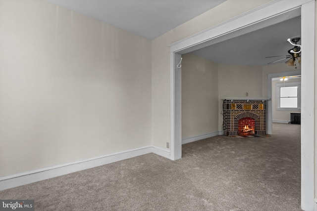 interior space with ceiling fan and a fireplace