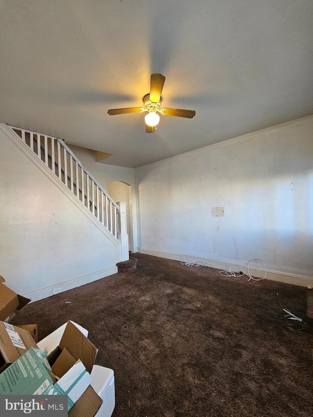 staircase with carpet and ceiling fan