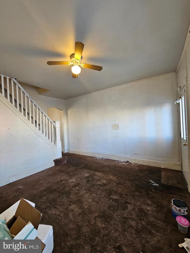 interior space with carpet floors and ceiling fan