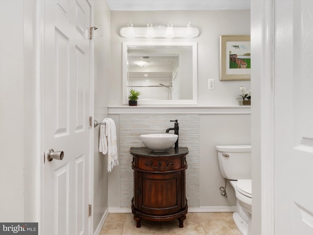 bathroom featuring tile patterned floors, vanity, and toilet