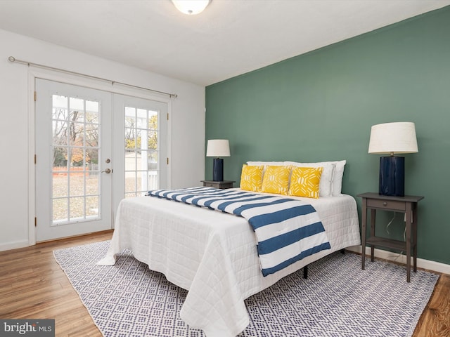 bedroom featuring access to outside, french doors, and hardwood / wood-style flooring