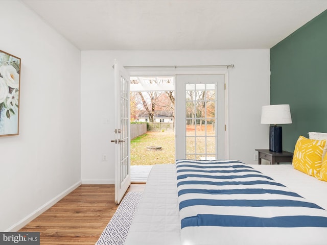 bedroom featuring access to outside and hardwood / wood-style flooring