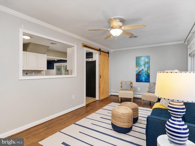 living room featuring ornamental molding, ceiling fan, dark wood-type flooring, a barn door, and a baseboard radiator