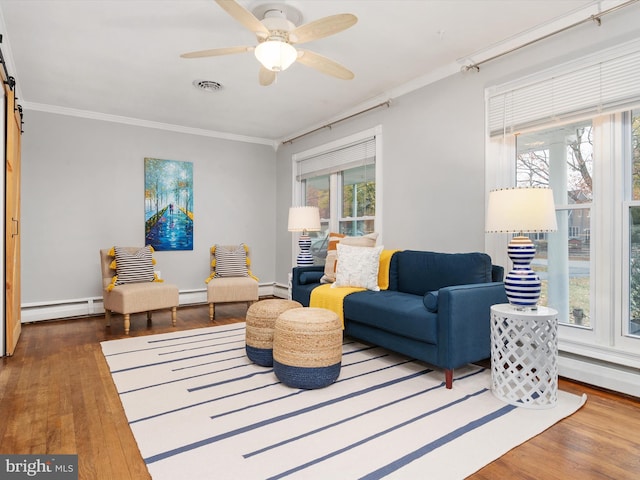 living area featuring plenty of natural light, crown molding, and dark wood-type flooring