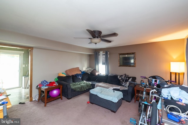 carpeted living room with ceiling fan