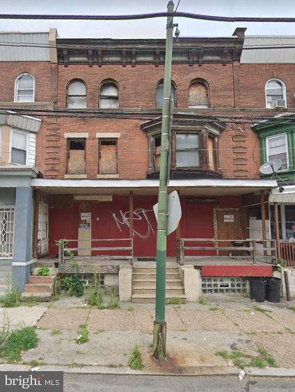 4023 W Girard Ave, Philadelphia, PA 19104 - view of front of property featuring brick siding and a porch