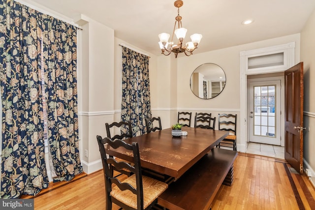 dining room featuring light hardwood / wood-style flooring and an inviting chandelier