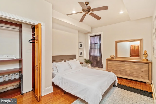 bedroom featuring a closet, light wood-type flooring, and ceiling fan