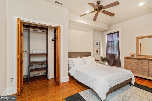 bedroom with a closet, ceiling fan, and wood-type flooring