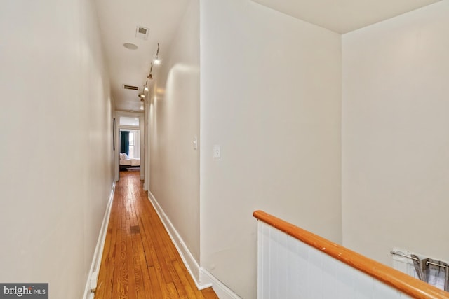 hallway with hardwood / wood-style floors