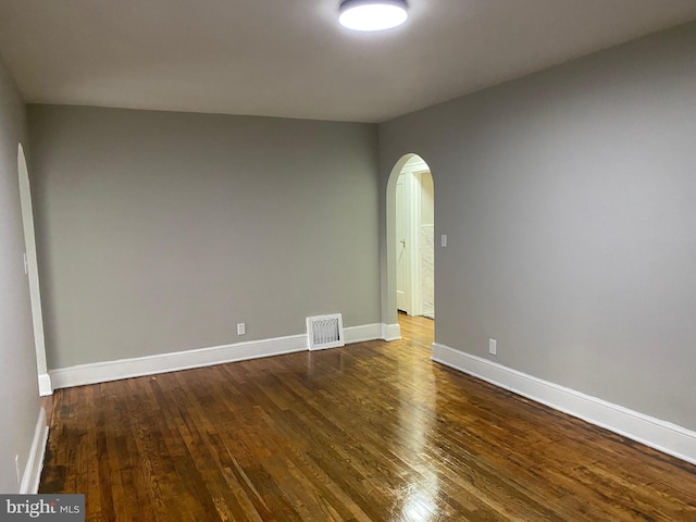 empty room featuring dark hardwood / wood-style flooring