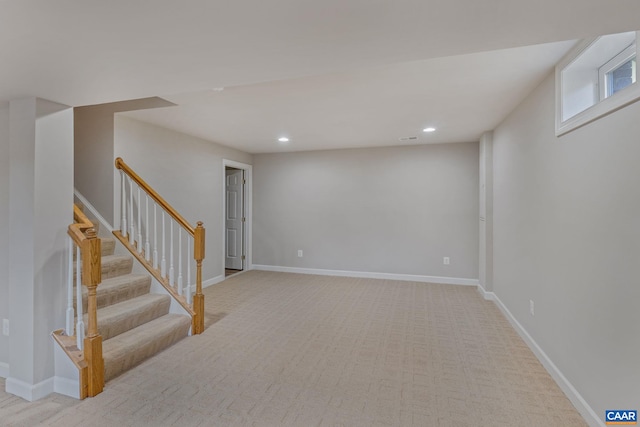 basement with stairway, recessed lighting, and baseboards