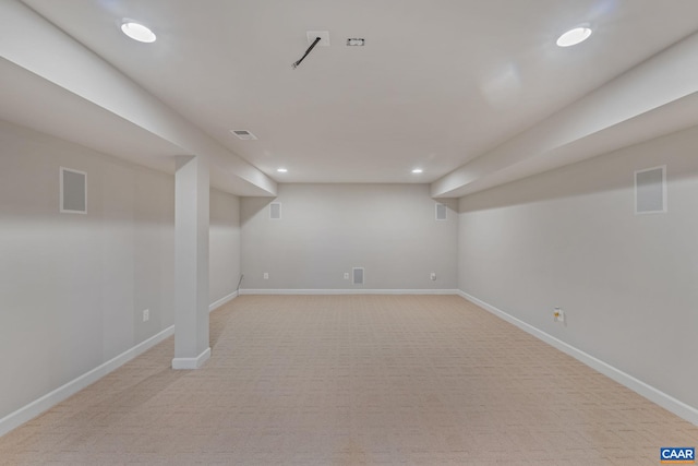 finished basement with visible vents, recessed lighting, light colored carpet, and baseboards