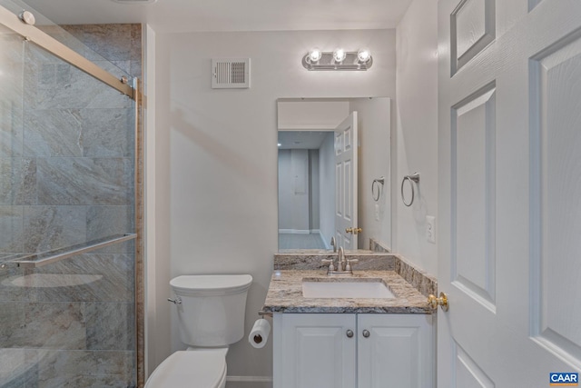 bathroom featuring visible vents, a stall shower, vanity, and toilet