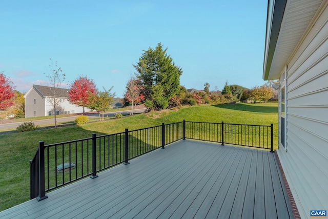 wooden deck featuring a lawn