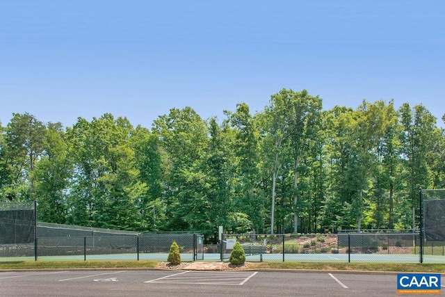 view of tennis court with fence