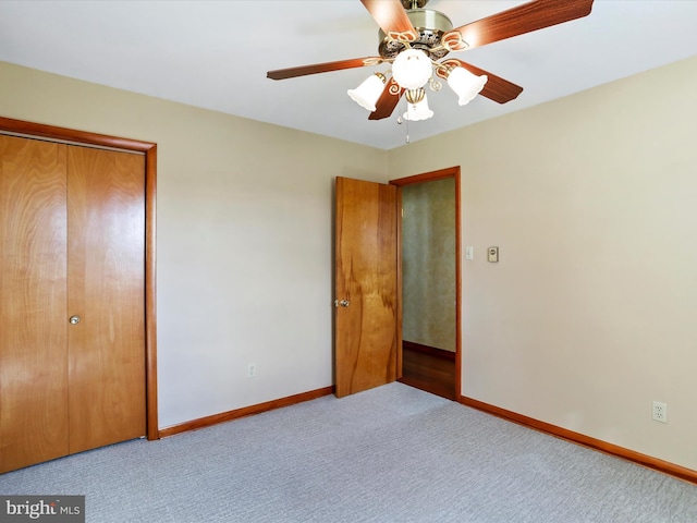 unfurnished bedroom featuring a closet, ceiling fan, and light colored carpet