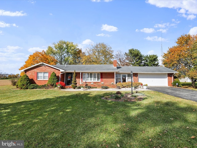 ranch-style house with a garage and a front lawn