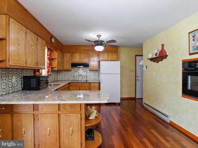 kitchen featuring black appliances, sink, a baseboard radiator, kitchen peninsula, and dark wood-type flooring